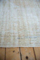 Distressed vintage Oushak rug pile, showcasing worn texture and subtle blue-green tones.