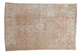 Distressed Oushak carpet featuring faded rose and ivory medallion and cloudband motifs. 5'9