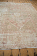 Distressed Oushak rug surface with visible foundation, worn knot heads, faded ivory and rose tones.