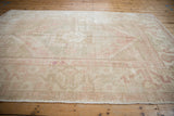 Textured pile of vintage distressed Oushak rug showing soft dusty rose and antique ivory tones.