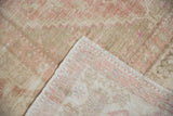 Vintage distressed Oushak rug pile showing exposed foundation and backing weave.