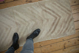 Distressed Tulu runner featuring a textured pile and playful multi-tier arrowed design.