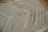 Textured pile of a vintage Tulu rug, displaying distressed ivory and pale brown arrowed motif.