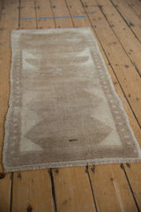 Distressed vintage Turkish Tulu runner with primitive beige triangular motifs and narrow seeded border.