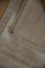 Hand-knotted vintage Tulu rug's reverse, showing beige-sand texture and intact side cord selvage.
