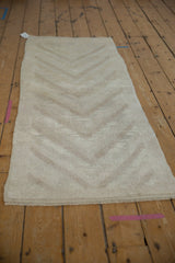 Textured pile of the vintage Distressed Tulu runner featuring subtle ivory arrow designs.