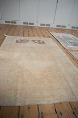 Vintage Distressed Oushak rug with prominent abrash, faded stepped medallion, and soft tone-on-tone palette.