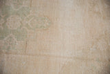 Distressed vintage Oushak rug texture with even wear, cream, and sea foam green tones.