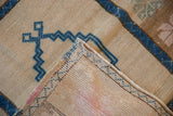 Distressed vintage Oushak rug edge, sapphire blue geometric pattern, intact selvage, and faint foundation.