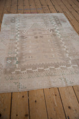 Decorative distressed texture and geometric motifs in ivory, silver, and seafoam green.