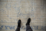 A detailed view of the distressed Oushak's texture with wear to the foundation.