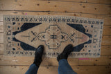 Distressed Oushak runner showcasing faded peach, navy, and antique ivory with an abrashed field.