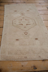 Distressed Oushak rug pile with even wear to knot heads and original selvage.