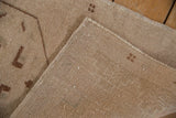 Distressed Oushak rug reverse showing hand-knotted foundation, tight weave, and original side selvages.