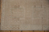 Distressed vintage Oushak rug detail: low pile, knot heads, beige abrashes, intact selvage.