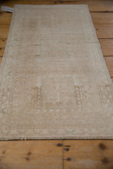 Distressed pile texture and muted beige abrashes on a vintage Oushak rug.
