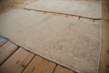Angled view of a distressed Oushak rug runner highlighting its low pile and even wear.