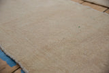 Evenly worn, hand-knotted pile of a distressed vintage Turkish Oushak rug.