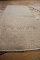 Low, even wear across the hand-knotted pile of a distressed vintage Oushak rug runner.