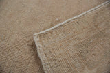 The hand-knotted foundation and original side cord selvage of a vintage Turkish Oushak rug.