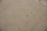 Reverse side of a vintage Turkish Oushak rug showing the hand-knotted foundation and painted marks.