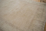 Vintage Distressed Oushak rug pile texture with worn knot heads in faded sand.