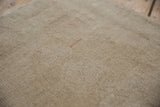 Distressed Oushak rug pile showing knot heads in faded sand and antique ivory.
