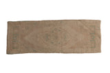 Vintage Distressed Oushak runner with faded serrated medallion, subtle ivory and sage green patterns.