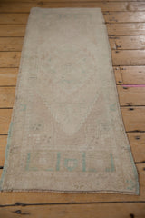Vintage Distressed Oushak runner, soft low pile showing faded serrated medallion.