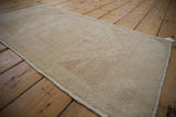 Distressed Oushak rug pile with subtle floral elements, even wear, and antique ivory.