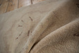 Detail of low pile and knot heads on a distressed hand-knotted Oushak rug.