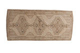 Vintage distressed Oushak runner featuring triple geometric medallions, neutral palette, 1'8