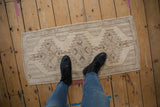 Distressed Oushak rug runner, triple serrated medallion in antique ivory with faded cobalt blue.