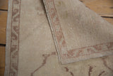 Hand-knotted back and distressed ivory pile of a vintage Turkish Oushak rug with selvage.