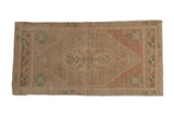 Distressed vintage Oushak rug with shield medallion, end finials, abrashed rose, ivory, and faded teal. 1'6