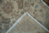 Back of the vintage Oushak rug showing the hand-knotted foundation and secured side selvage.