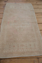 Detailed view of vintage distressed Oushak rug showing faded floral fills and soft pile.