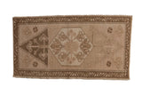 Distressed Oushak rug mat, abrashed light brown and antique ivory geometric floral medallion.