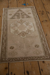 Distressed Oushak rug, faded floral buds and finials on abrashed dusty rose ground.