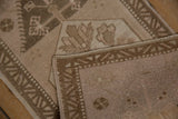 Distressed Oushak rug's reverse foundation, intact side selvage, and worn pile revealing structure.