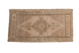 Vintage Distressed Oushak rug mat with faded beige, ivory, and brown stepped medallion, 1'9