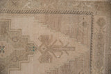 Stepped geometric design and short, even pile on a distressed vintage Oushak rug.
