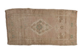 Vintage distressed Oushak rug mat with a faded central medallion in blush, seafoam green, and antique ivory.