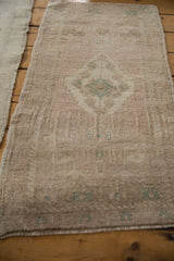 Intact side cord selvage and even, short pile on a vintage distressed Oushak rug.