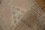 Detail of the vintage Oushak rug's intact side cord selvage and woven back.