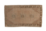 Distressed Oushak rug mat with muted antique ivory, light brown, and faint teal medallion shapes.