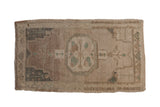 Vintage distressed Oushak rug mat with roundel floral medallion and abrashed field.
