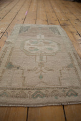 Vintage distressed Oushak rug pile, showing even wear and intact side cord selvage.