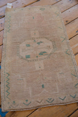 Corner close-up, distressed pile, antique ivory beige, faded jade geometric Oushak rug.