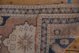 Distressed vintage Oushak rug pile texture and hand-knotted foundation.